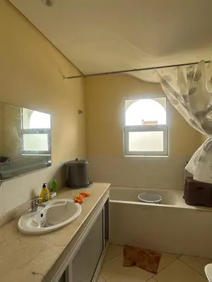 a bathroom with a sink and a bath tub at New and cosy appt for rent in Sidi Rahal