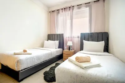 a bedroom with two beds and a window at Comfortable Getaway Near the Beach in Dar Bouazza