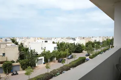 a view of a street in a city with buildings at Comfortable Getaway Near the Beach in Dar Bouazza