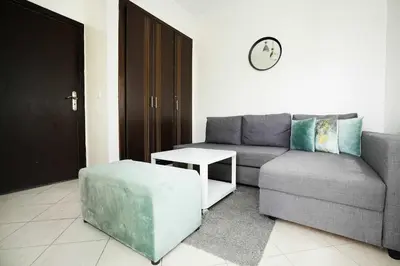 a living room with a couch and a table at Cozy Apartment in the Heart of Bouznika in Bouznika