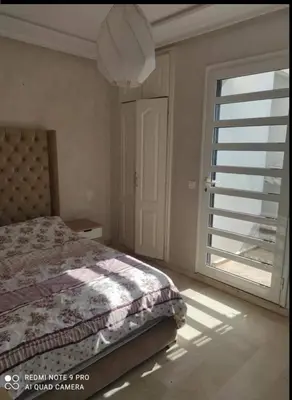 a bedroom with a bed and a large window at اقامة فال دانفا in Casablanca