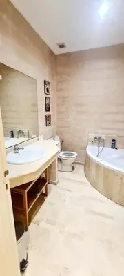 a bathroom with two sinks and a tub and a toilet at اقامة فال دانفا in Casablanca