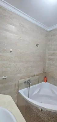 a bathroom with a bath tub and a sink at اقامة فال دانفا in Casablanca