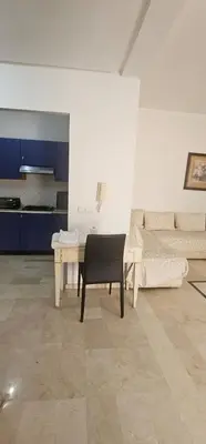 a living room with a table and a couch at اقامة فال دانفا in Casablanca