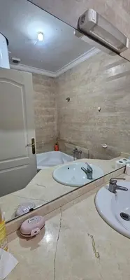 a bathroom with two sinks and a mirror at اقامة فال دانفا in Casablanca