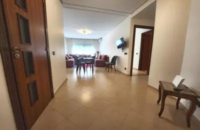 a living room with a table and a dining room at Serenity in Rabat's downtown in Rabat