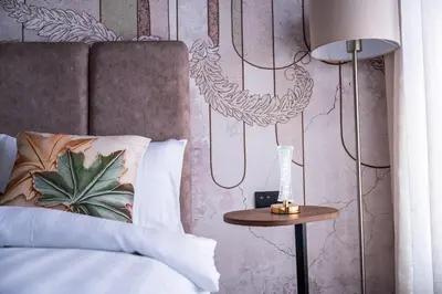 a bedroom with a bed and a table with a lamp at Terracotta Chic Studio Cosy Les Princesses Casablanca in Casablanca