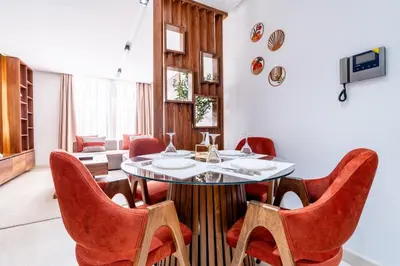 a dining room with a table and red chairs at Terracotta Chic Studio Cosy Les Princesses Casablanca in Casablanca