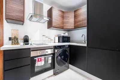 a kitchen with a washing machine and a sink at Terracotta Chic Studio Cosy Les Princesses Casablanca in Casablanca