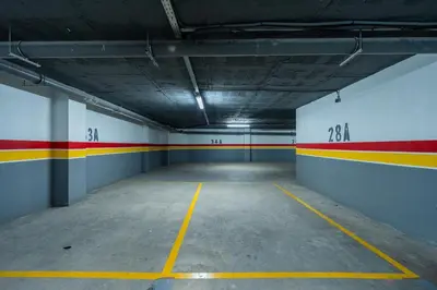 an empty parking garage with red and yellow stripes on the walls at Terracotta Chic Studio Cosy Les Princesses Casablanca in Casablanca