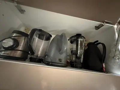a shelf with a bunch of appliances on it at Appartement 2 chambres a coucher dans un residence securise au centre Mohamadia in Mohammedia