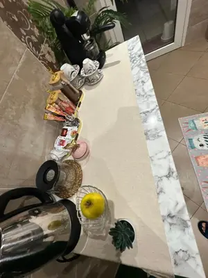 a table with a pineapple and a lemon on it at Appartement 2 chambres a coucher dans un residence securise au centre Mohamadia in Mohammedia