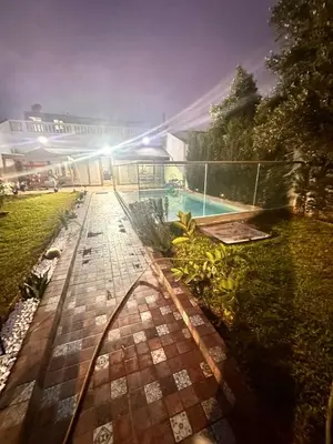 a view of a backyard with a swimming pool at Belle maison avec piscine à 7 min de la plage en voiture in Dar Bouazza