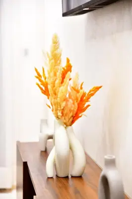 a white vase with flowers in it on a table at Le Supreme Chic in Casablanca