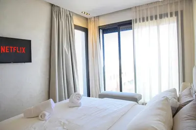 a hotel room with a bed and a large window at Le Supreme Chic in Casablanca