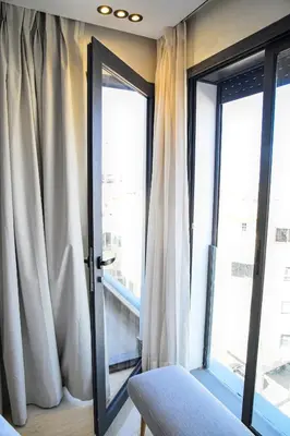 a room with a glass door and a window at Le Supreme Chic in Casablanca