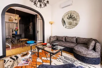 a living room with a couch and a table at Assayag Art Deco - 1930 in Casablanca