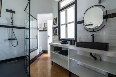 a bathroom with a sink and a mirror at Assayag Art Deco - 1930 in Casablanca