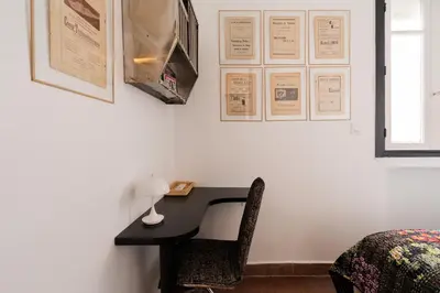 a bedroom with a desk with a chair and a bed at Assayag Art Deco - 1930 in Casablanca