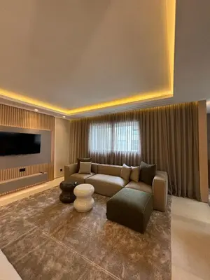 a living room with a couch and a tv at LabelCapitale in Rabat