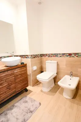 a bathroom with a white toilet and a sink at Lagoon Garden - 2 chambres proche Plage avec Piscine in Skhirat
