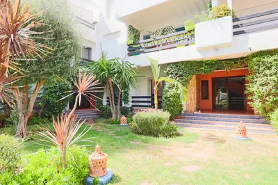 a house with a garden in front of it at Lagoon Garden - 2 chambres proche Plage avec Piscine in Skhirat