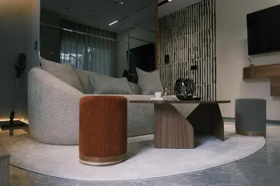 a living room with a couch and a table at Luxury Warm-Wood Duplex - Rooftop Sky Pool Access in Casablanca