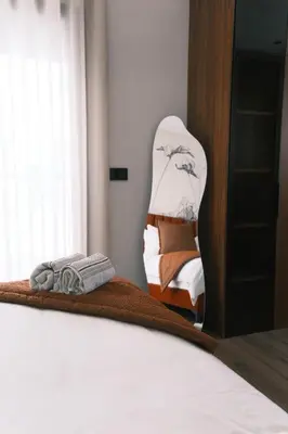 a bedroom with a bed and a mirror at Luxury Warm-Wood Duplex - Rooftop Sky Pool Access in Casablanca