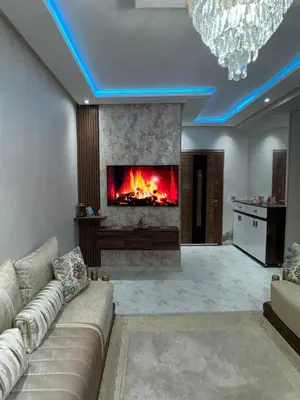 a living room with a couch and a fireplace at Appartement abwab tamaris in Dar Mouddene