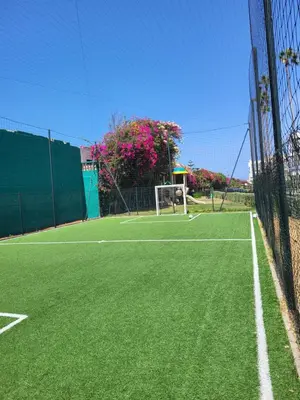 a tennis court with a net and a goal at Superbe appartement de 3 chambres avec piscines in Tamaris