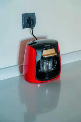 a red toaster sitting on top of a table at cozy appartement, convenient local in Casablanca