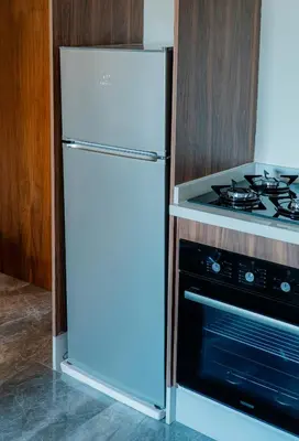 a white refrigerator in a kitchen next to a stove at cozy appartement, convenient local in Casablanca