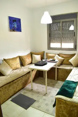 a living room with a couch and a table at Havre de paix appartement in Mohammedia