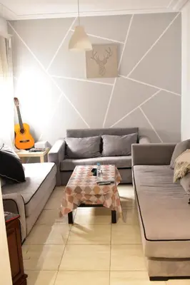 a living room with two couches and a table at Havre de paix appartement in Mohammedia