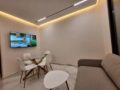 a living room with a couch and a table and chairs at Appartement to stay in Casablanca, CfC in Casablanca