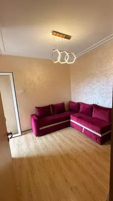 a living room with a purple couch and a chandelier at Tamaris in Casablanca