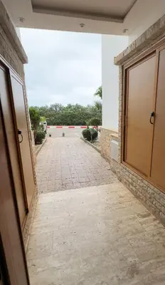 a walkway leading to a building with a door at Tamaris in Casablanca