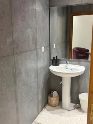 a bathroom with a sink and a mirror at Stylish 2BR in Central Rabat with Panoramic View in Rabat