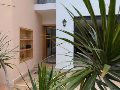 a house with a potted plant next to a building at Villa 3-bedroom with Private Pool in Tamaris in Tamaris