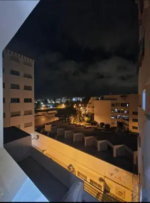 a view of a city at night from a building at Appartement bien meublé in Rabat
