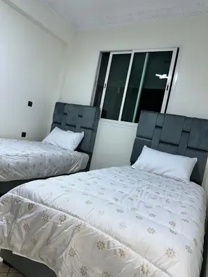 a bedroom with two beds and a window at Réservez dès maintenant Calme confort et proximité in Oulad Mbark