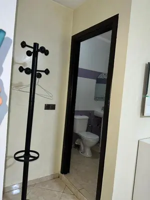 a bathroom with a toilet and a glass door at Réservez dès maintenant Calme confort et proximité in Oulad Mbark