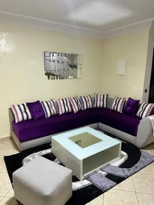 a living room with a couch and a coffee table at Réservez dès maintenant Calme confort et proximité in Oulad Mbark