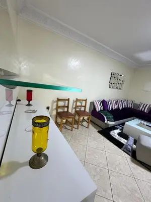 a living room with a table with a yellow glass on it at Réservez dès maintenant Calme confort et proximité in Oulad Mbark