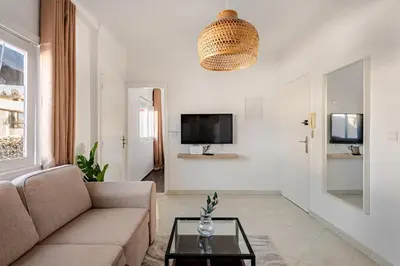a living room with a couch and a tv at Modern 1 Bedroom W Terrace-Arribat Center in Rabat