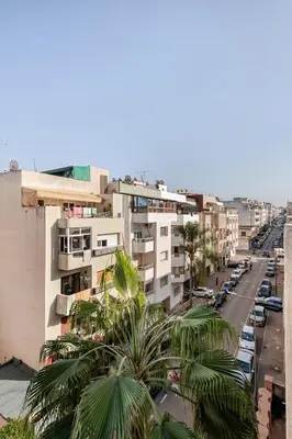 a view of a street with palm trees and buildings at Modern 1 Bedroom W Terrace-Arribat Center in Rabat