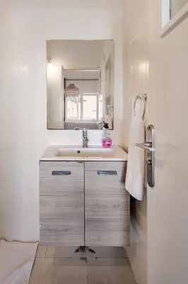 a bathroom with a sink and a mirror at Modern 1 Bedroom W Terrace-Arribat Center in Rabat