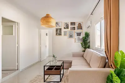 a living room with a couch and a table at Modern 1 Bedroom W Terrace-Arribat Center in Rabat