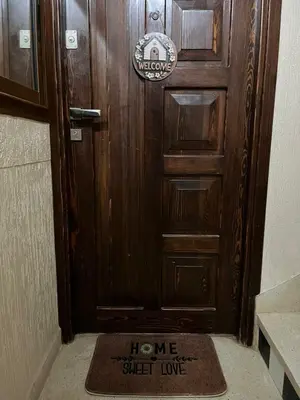 a welcome mat in front of a wooden door at Appartement meublé Centre de Témara in Temara