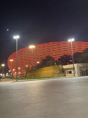 a stadium at night with a parking lot and lights at Appartement meublé Centre de Témara in Temara
